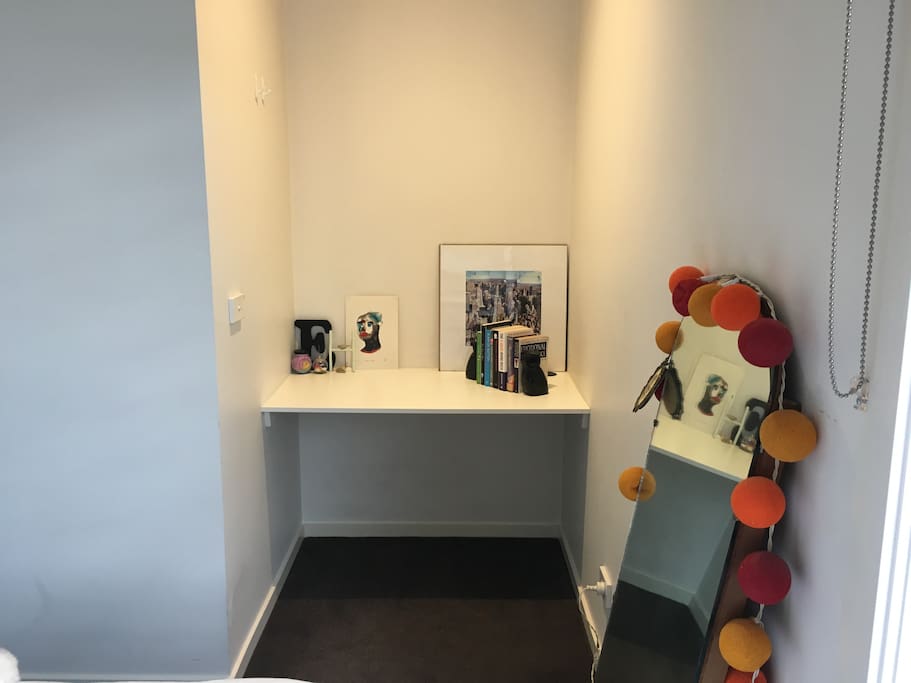 Study space and full length mirror in the room.