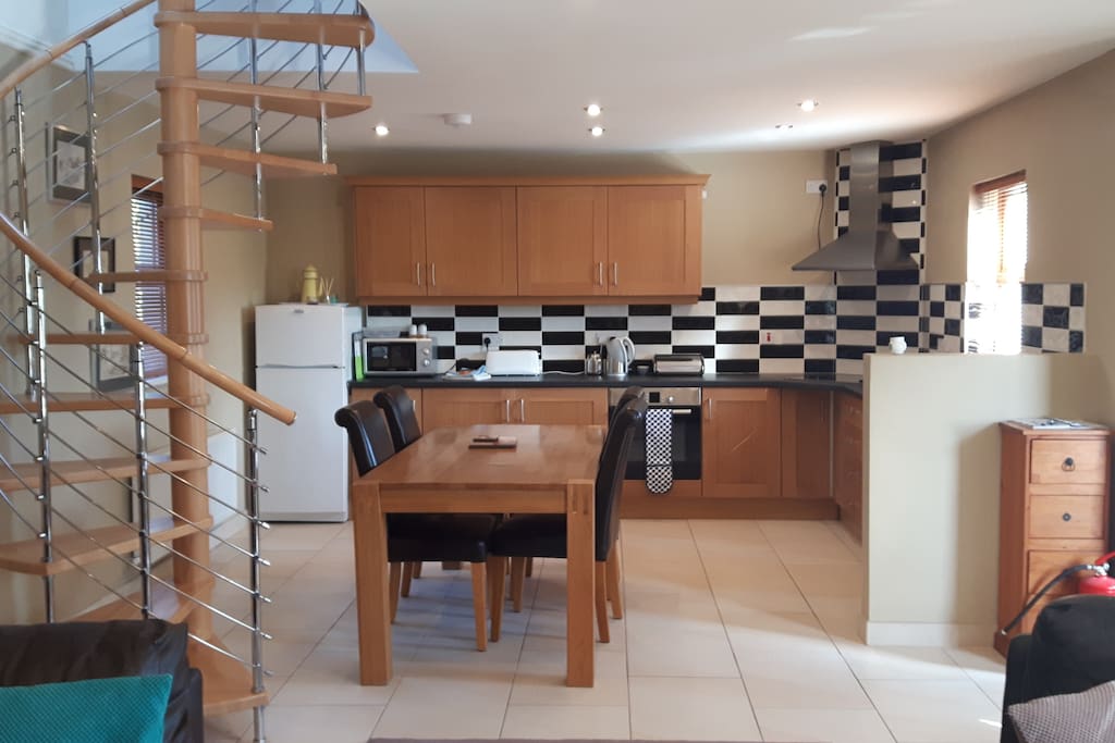 Open plan kitchen with spiral staircase