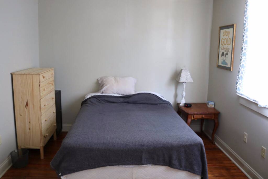 A closet and two dressers are available for storing clothes.