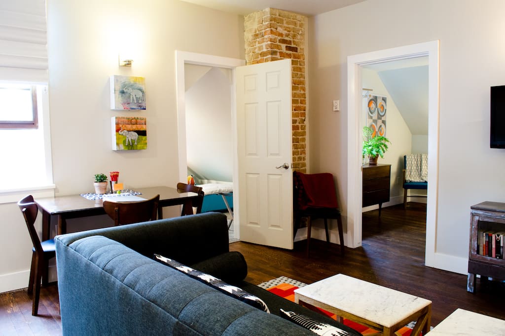 Space layout has a dining area and a separate couch / tv area.