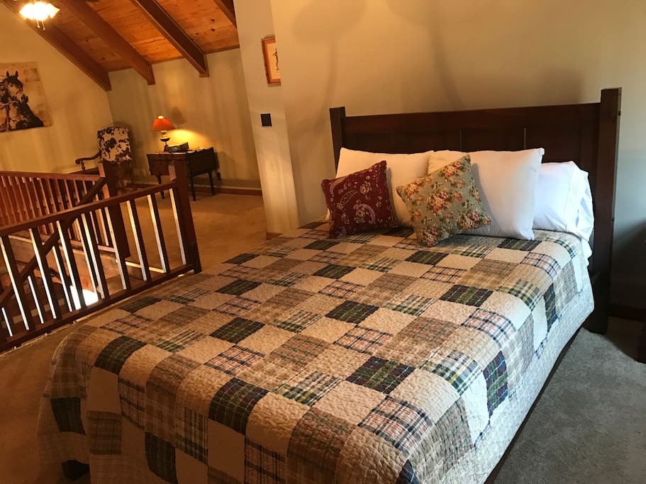 The loft bedroom has a queen-sized bed and offers a full bathroom with tub.