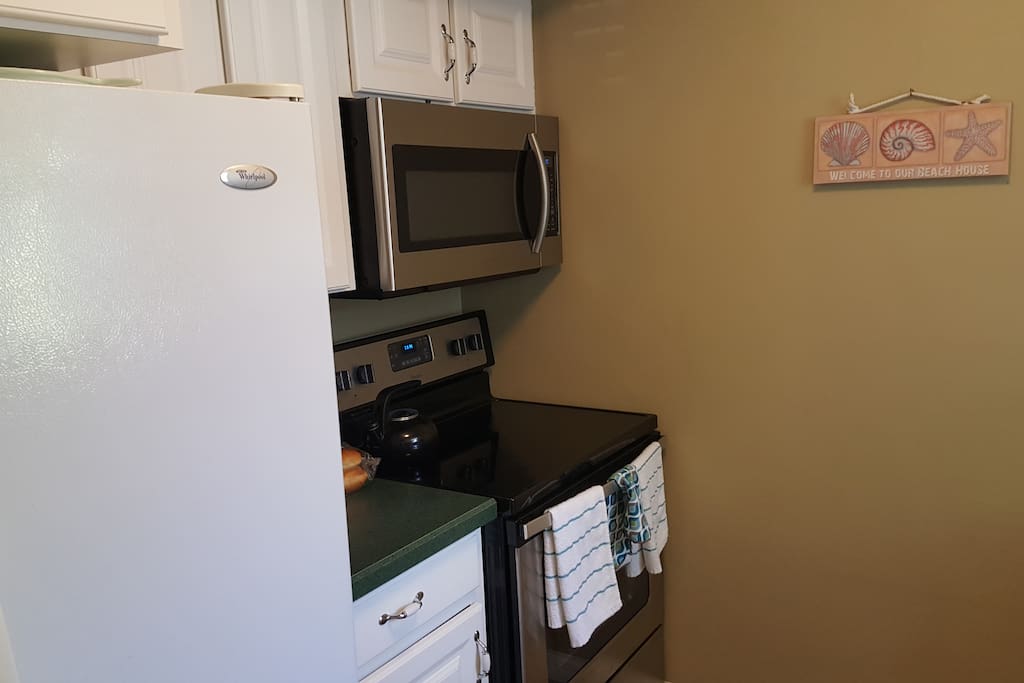 Kitchen is updated with new microwave and glass top stove