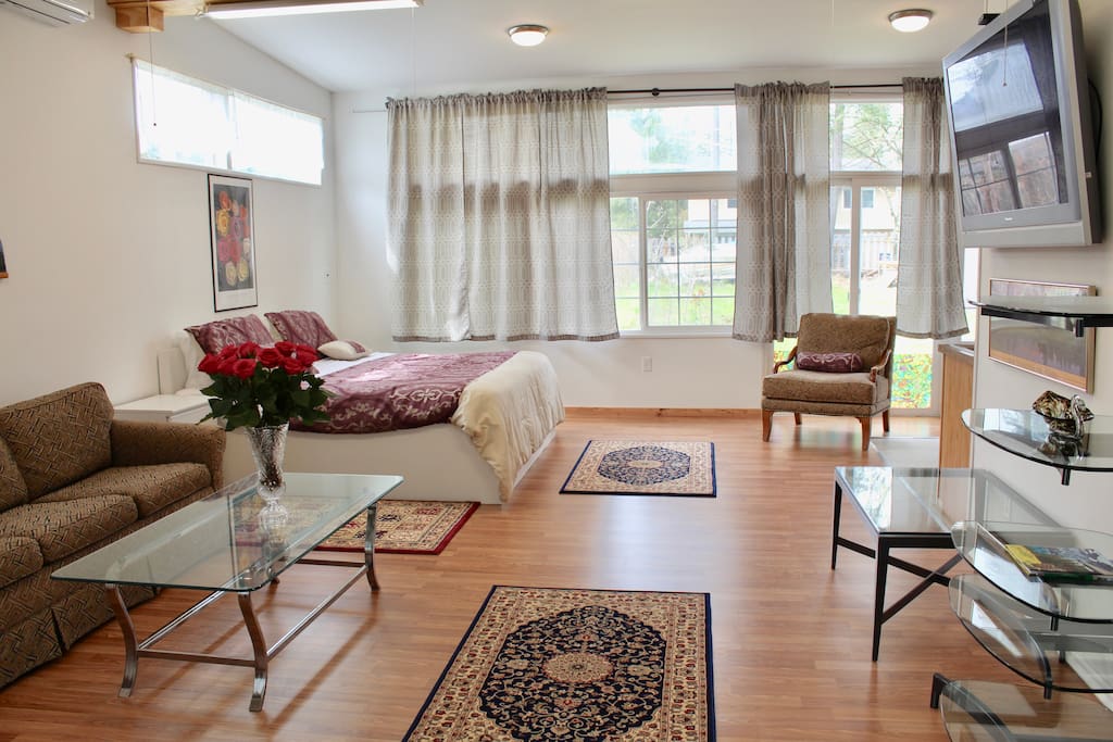 Spacious living area with sofa and large TV