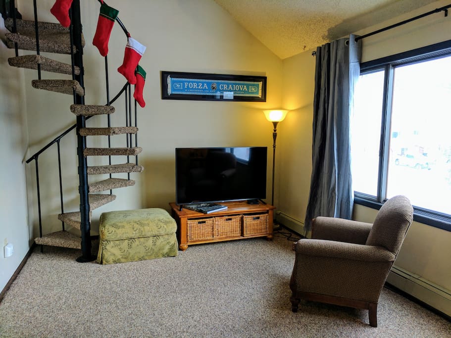 We have a 55" LED TV with basic cable and Netflix. We have many board games in the wicker baskets beneath the TV. Stairs to the loft to the left.