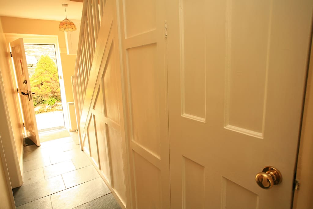 Hallway with original features & lots of under stairs storage.