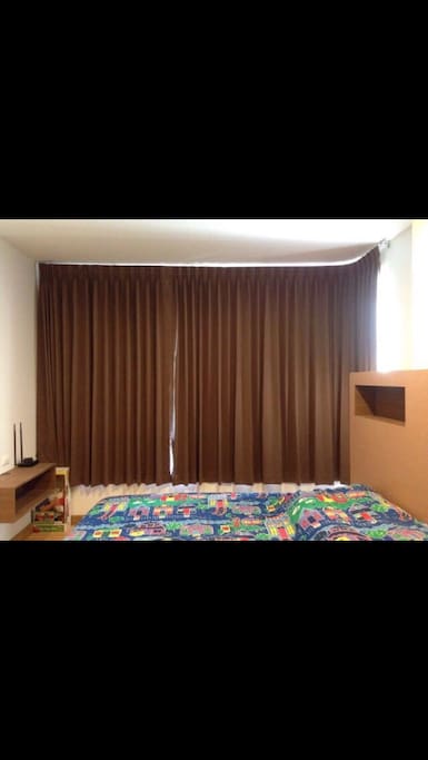 Double bedroom with blind curtains.