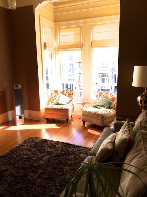 Living room with bay windows facing Haight St.
