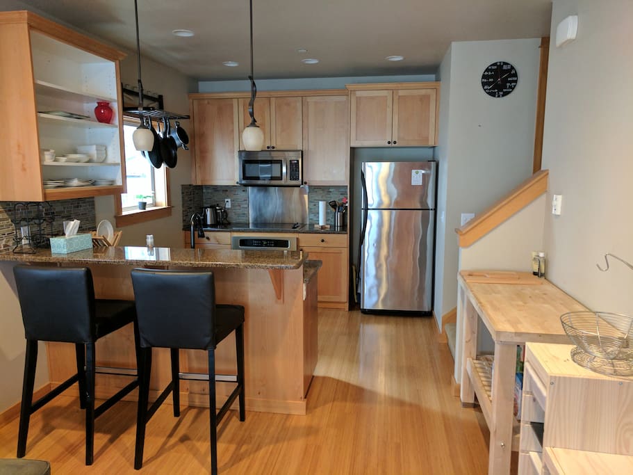 The second floor has a kitchen, dining/living space, and half bath.