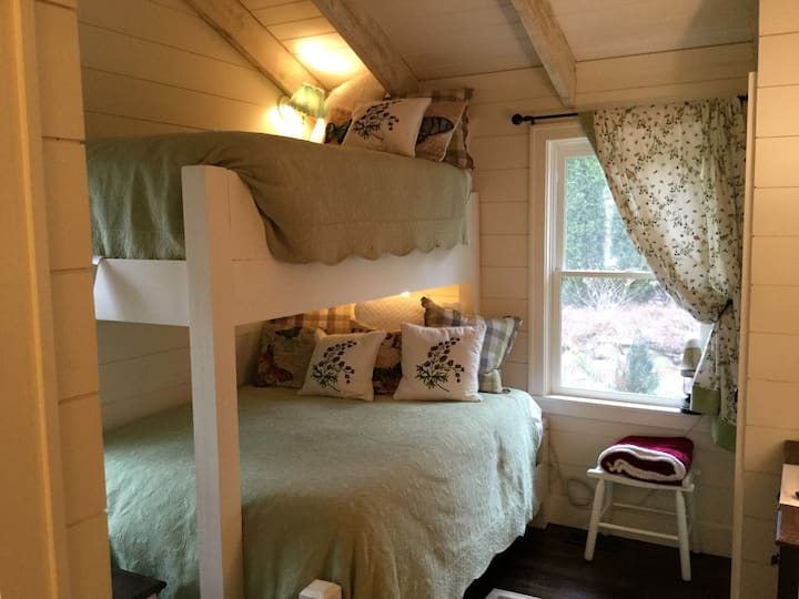 Warm, charming bunk room with larger full size mattress on bottom. 
Whimsical Scalamandre curtains add a youthful touch.  Small closet, chest of drawers and a TV to stream movies or to play a DVD.  Stairs to top bunk provide storage and movies.