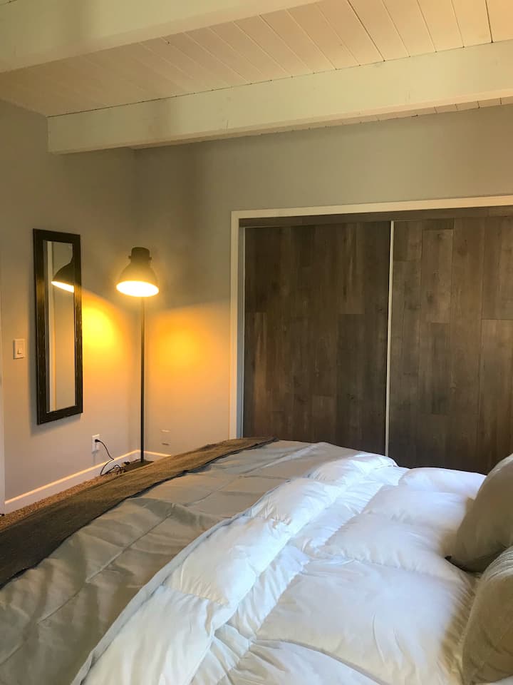 Master bedroom with exposed beam ceilings.