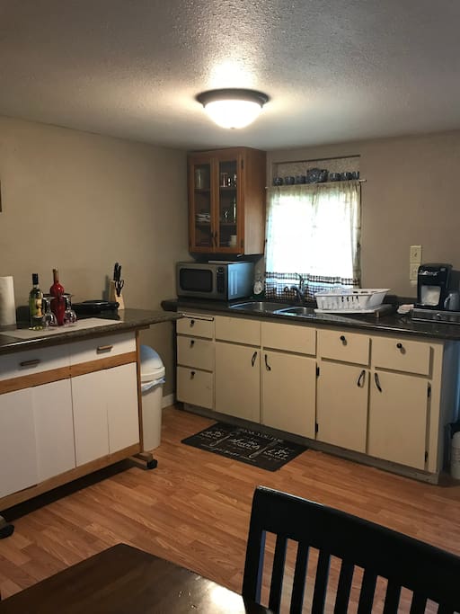 Kitchenette with granite counters, full sink, full size fridge, microwave, and single burner hot plate. All dishes, silverware, and basic cookware provided. Keurig and assortment of coffees also supplied for guests.