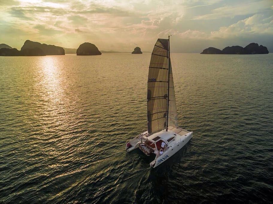 Private sailing into the sunset with a view of Thailand's gorgeous seascapes.