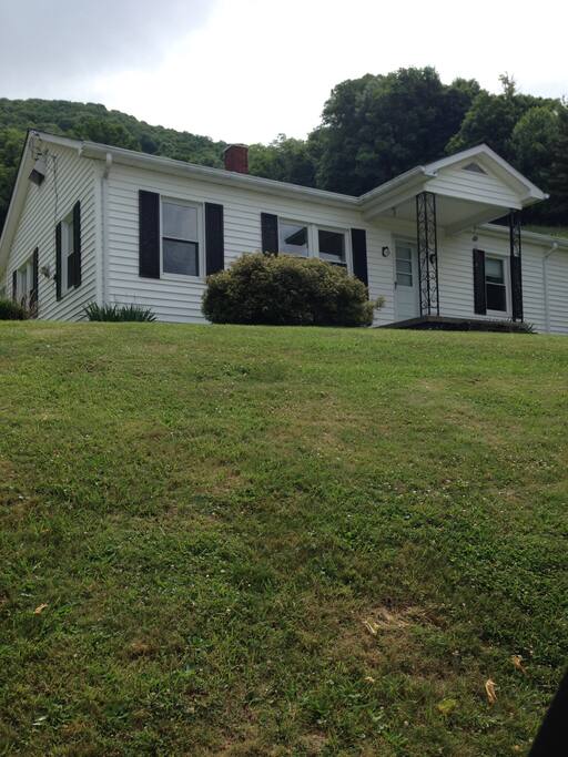 View of home from Tater Hill Rd. Lots of windows allow bright light. The house faces South and has a view of the back ski runs of Beech Mtn ski resort.