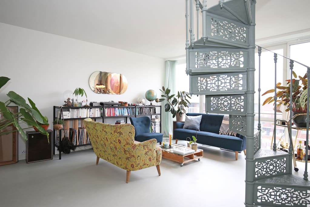 The living room with stairs going up to the greenhouse.