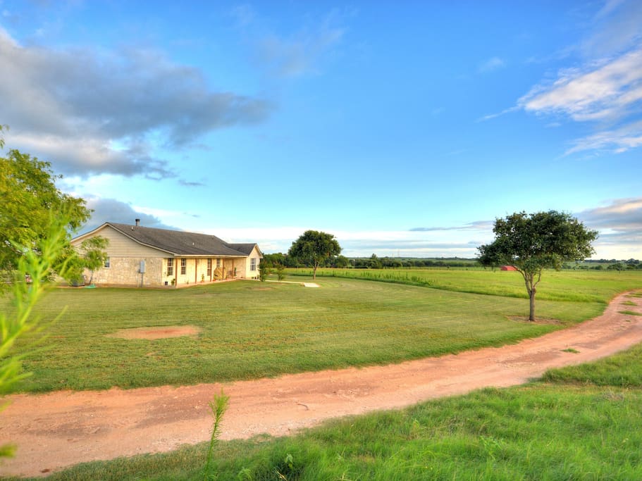 Ranchette house overlooks hay fields and horses grazing