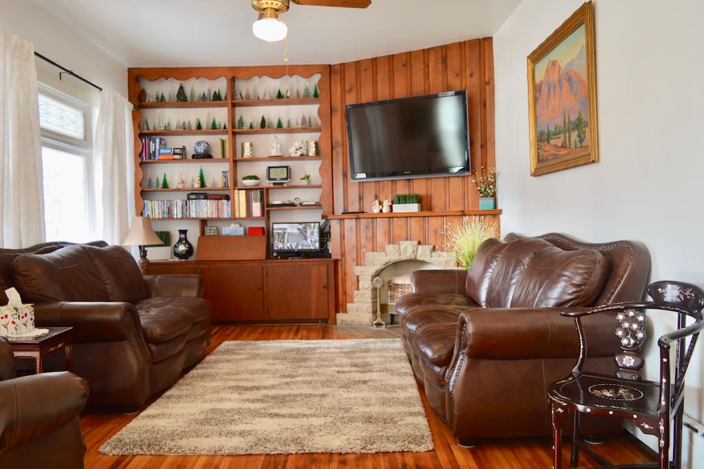 Relaxing Den with Ceiling Fan and Leather Couches and Recliner