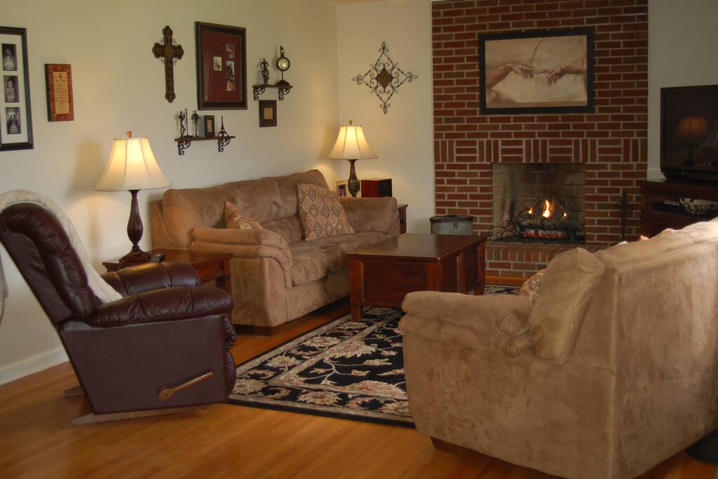 Living room with gas fireplace and lots of natural light.