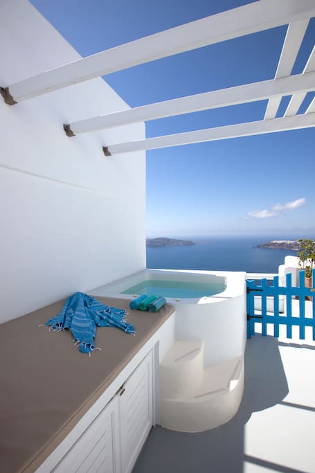 Private balcony with panoramic view at the sea, sunset, caldera and private outdodr big Jacuzzi Hot-tub
and double built sun-bed