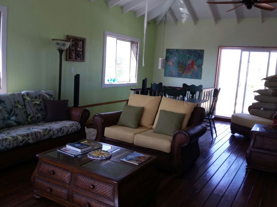 Up stairs living room from breakfast bar looking to the back deck door and stairs to lower level