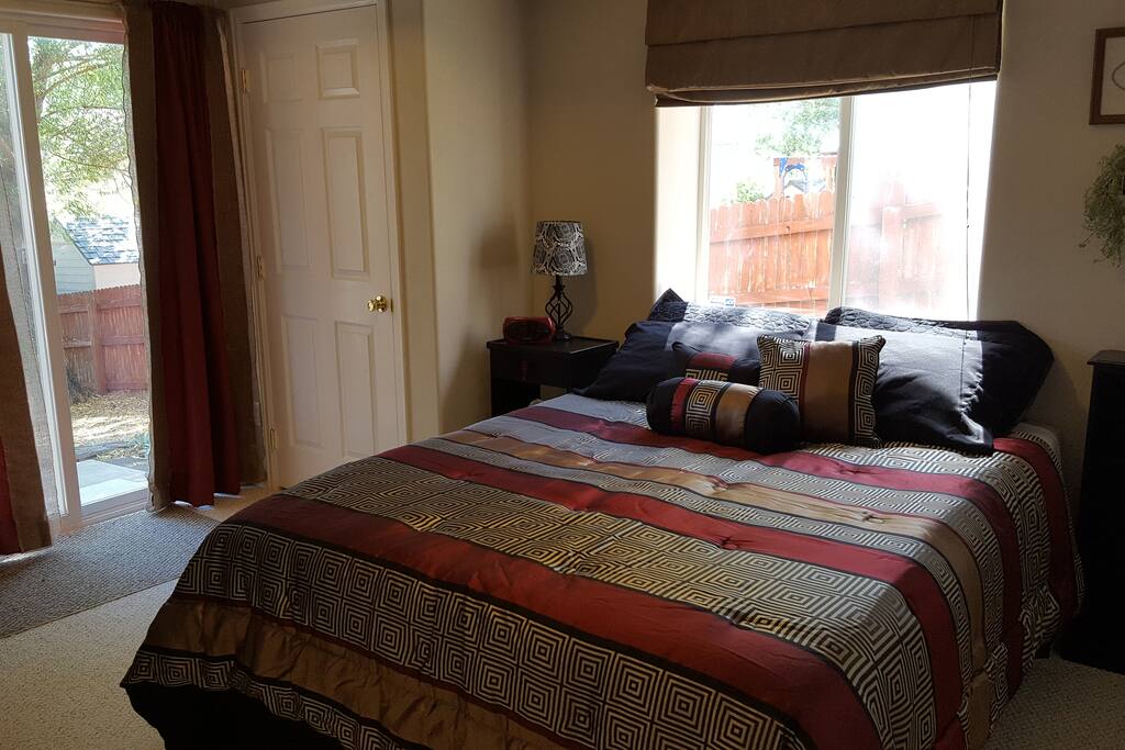 The bedroom includes a queen-sized bed with memory foam mattress topper. USB charging stations are accessible on both sides of the bed.