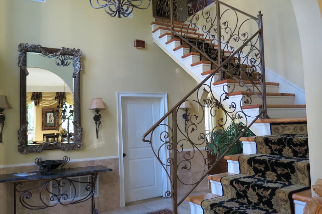 Entry way features beautiful stairway.