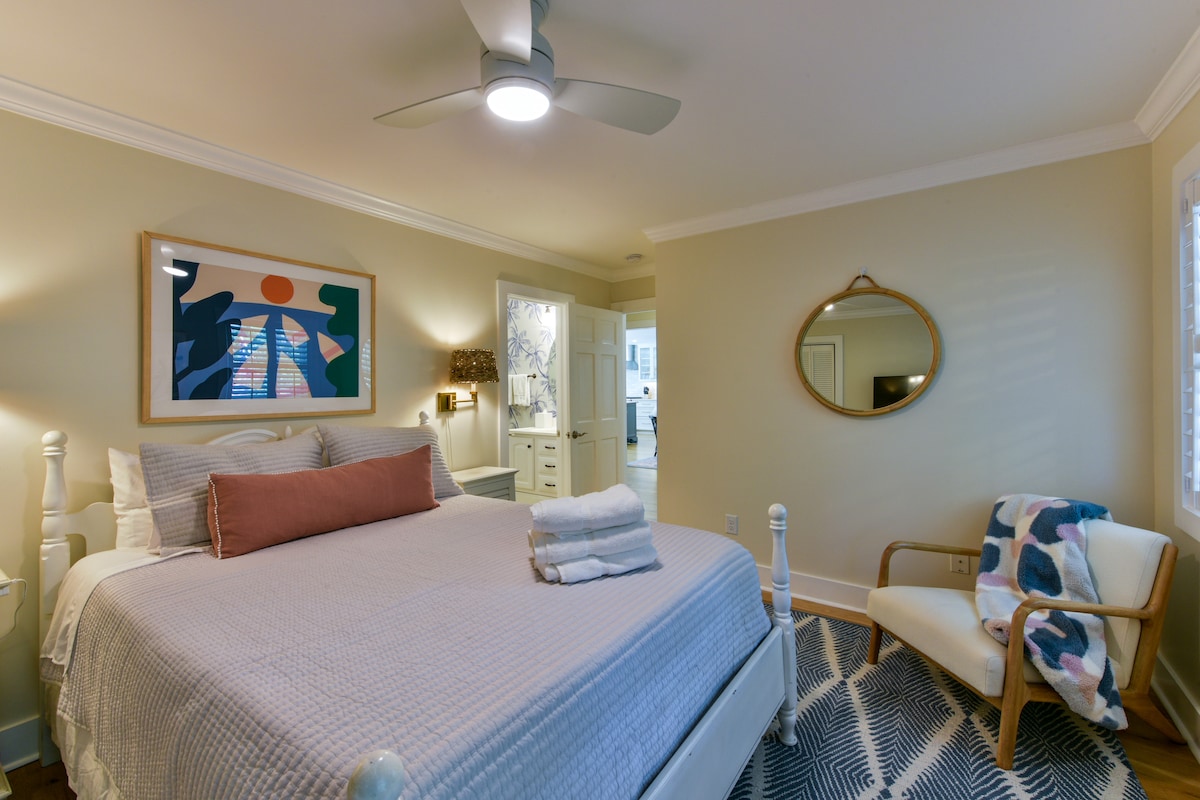 The “Dawn Room” is outfitted with a queen bed, swinging arm lamps over each bedside table and a chair for lounging.  It is attached to a full bathroom.  Soft sheets, a light comforter and plenty of pillows on the bed ensure a great nights’ sleep.  