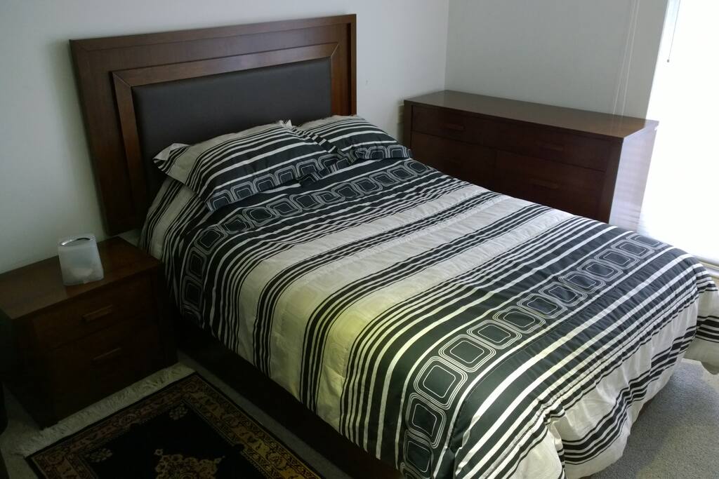 Master bedroom with balcony and street view.