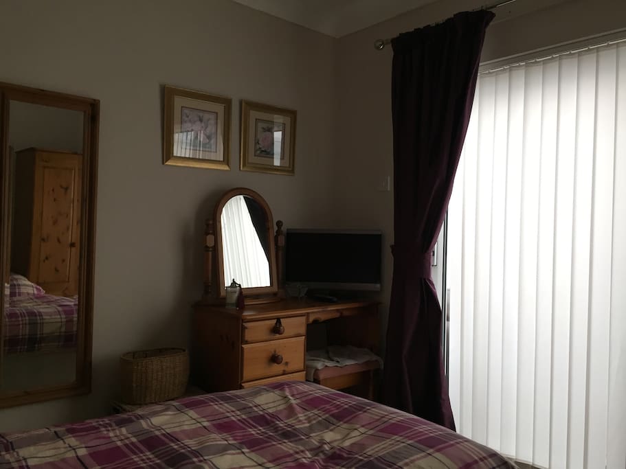 Mirror,dressing table and door to the conservatory