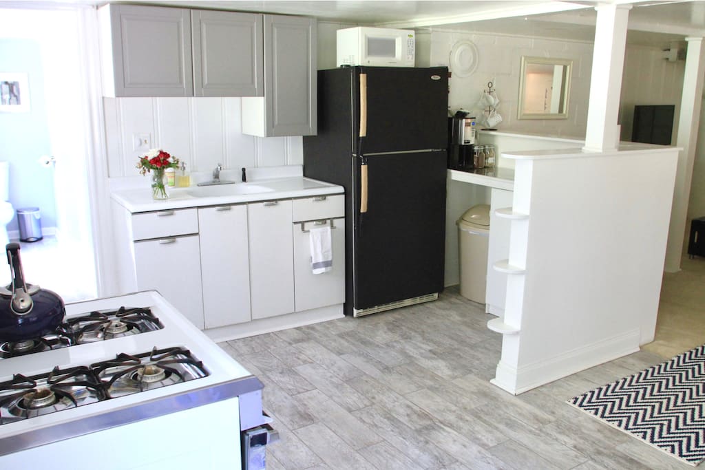 Kitchen with full size refrigerator, microwave, coffee pot (AND free trade coffee), and gas range/oven.
