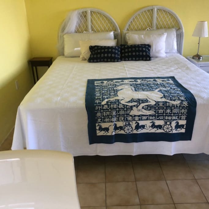 King-size bed with new pillows, sheets and covers. Water view from the bed, with covered deck outside.