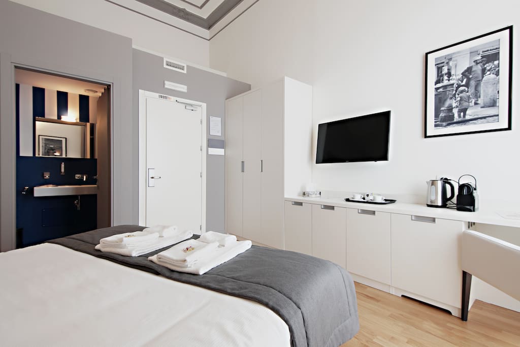 View of the double bedroom with a/c, tv, Nespresso machine and private balcony