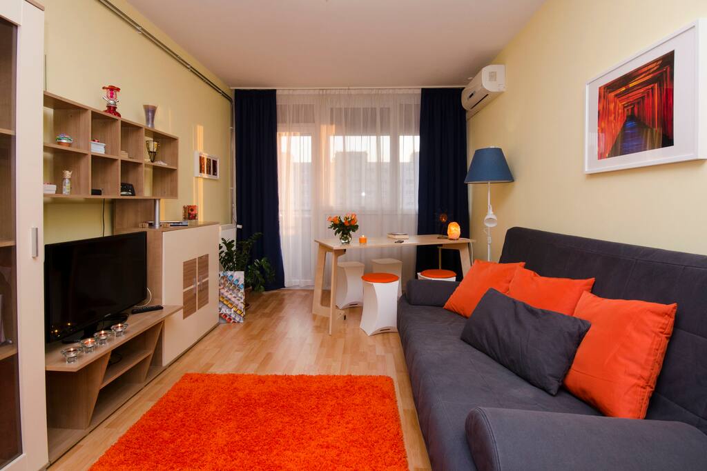 Living room with dining area and the exit to balcony