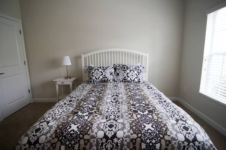 First bedroom with one queen bed.