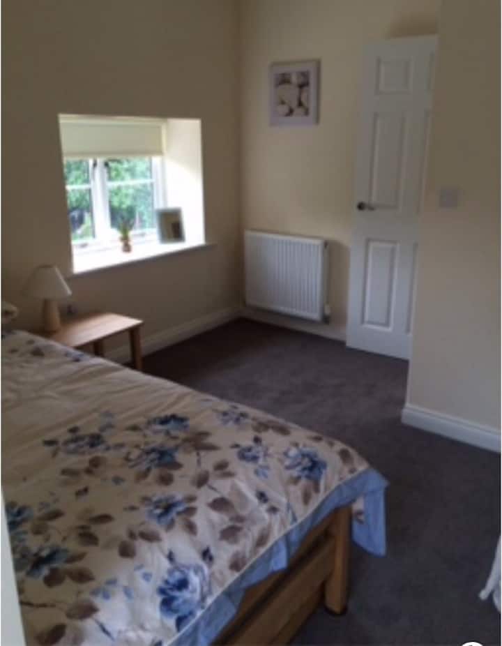 Single room with wardrobe & small set of drawers.
