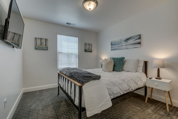 Bedroom 3 includes comfortable queen bed, smart TV and large closet with dresser.