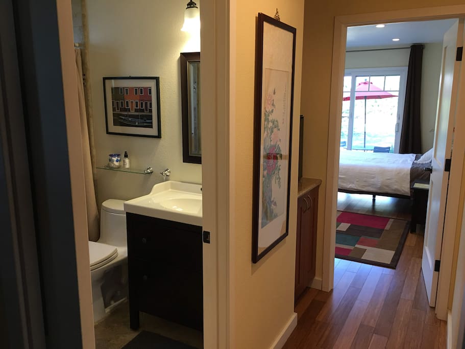 Attached private bath, with pocket door to separate from the rest of the house - mini fridge in hallway