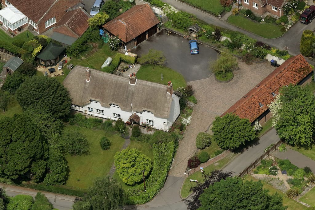 Church Farm Barn (on the right) and Church Farm House (thatched building on the left) share a private courtyard.