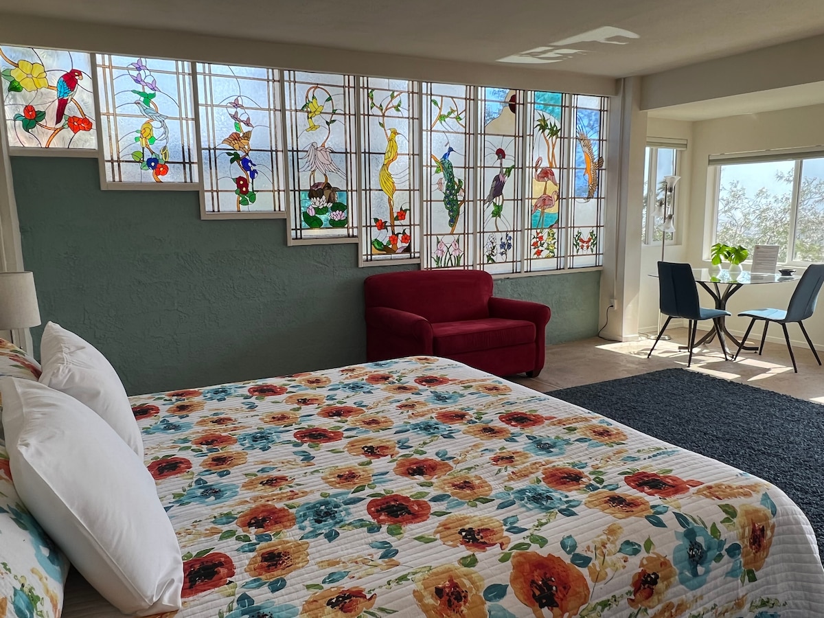 Our amazing custom King Size bed with REAL shag carpet.  Note the amazing stained glass windows.