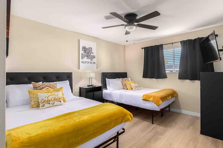 Two double beds with memory foam mattresses, premium linens, smart TV, dresser and closet storage space.