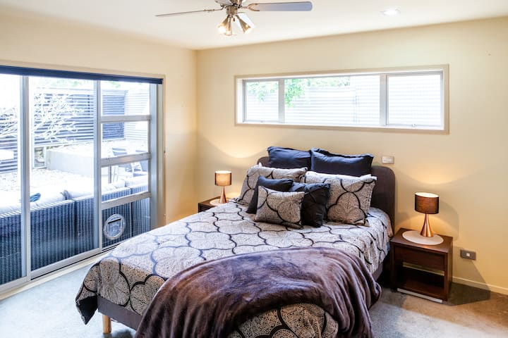 Master bedroom with queen bed, opens on to outdoor patio lounge area. Fans in the bedrooms are great for those hot summer nights. 