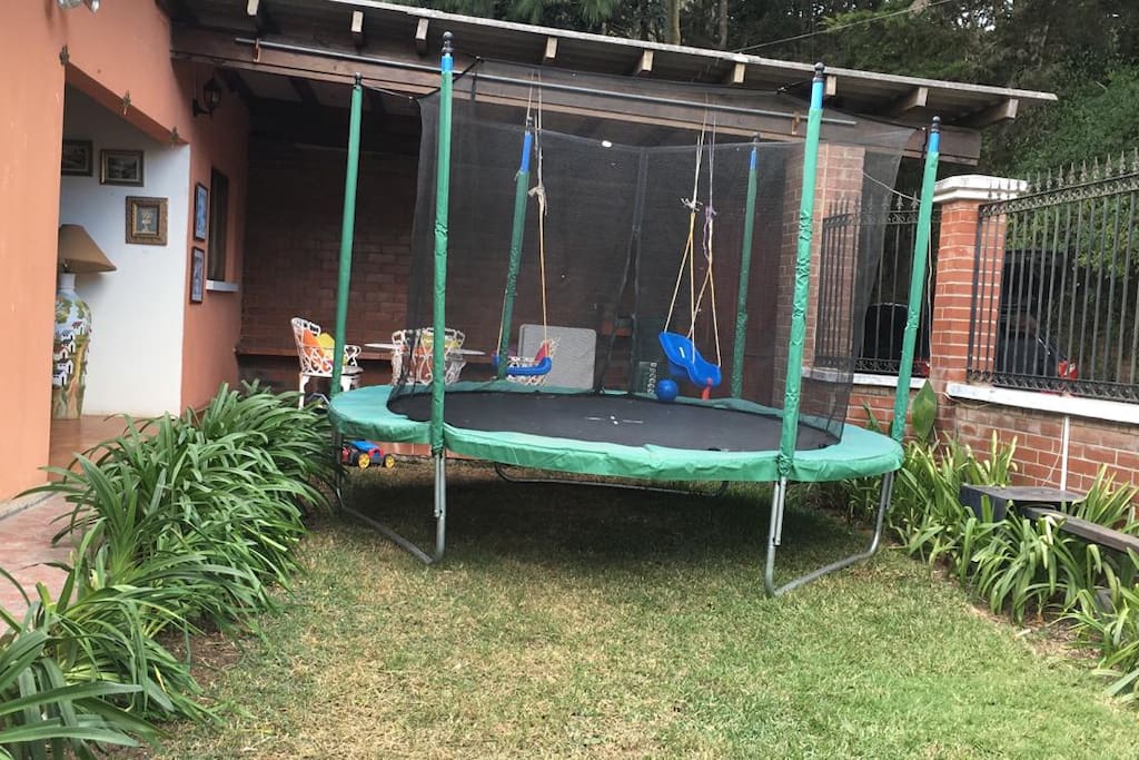 Trampoline with net and swings for kids