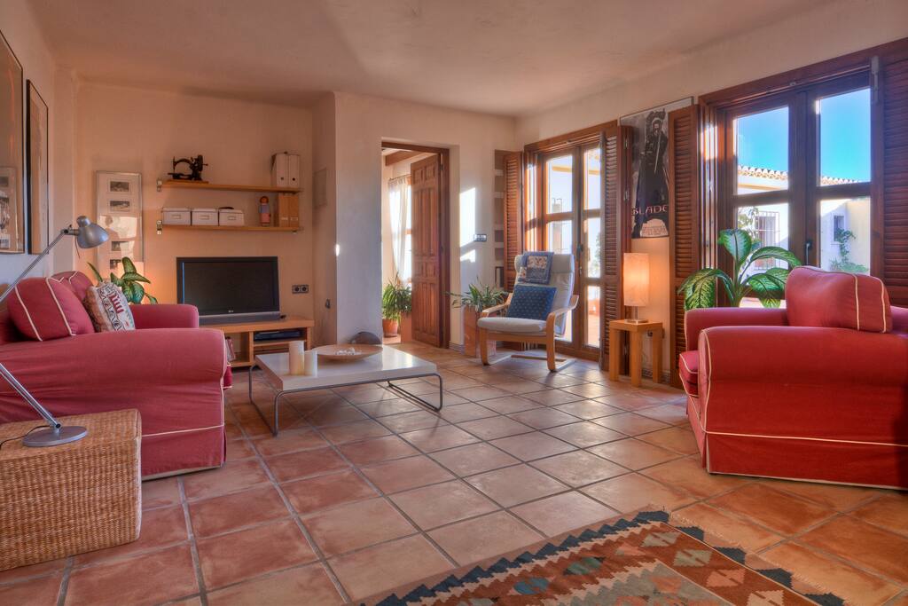 Big lounge for guests with AC/heating. Sofas and computer desk. Access from rooms and to sunset patio.