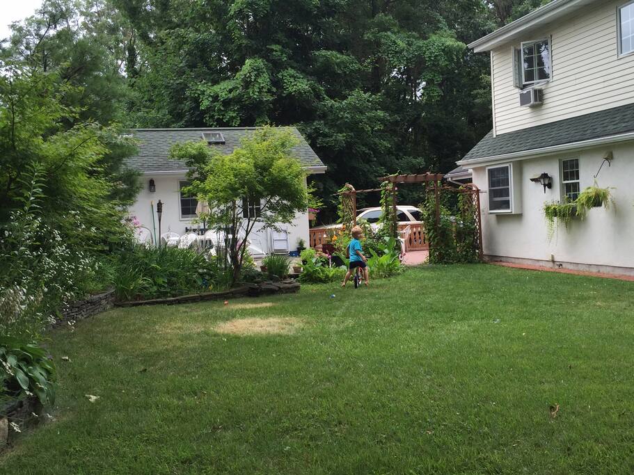 Beautiful enclosed yard with fish pond, garden, waterfall, patio with outdoor seating/ table