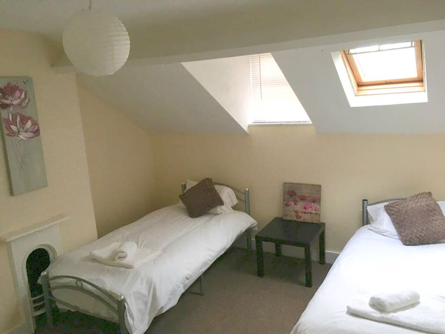 Large attic bedroom with 2 single beds & wardrobe