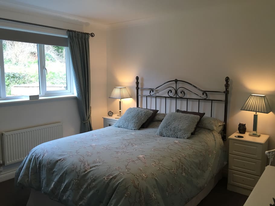 King-size bedroom with garden view.