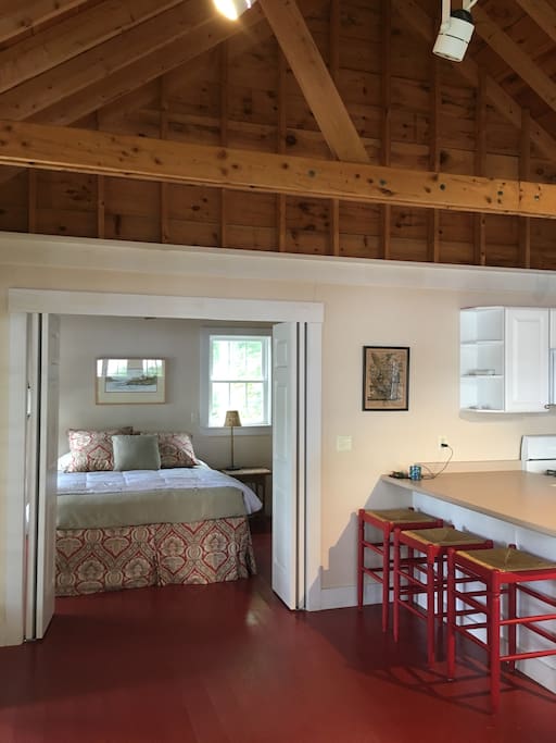 counter stools + queen bedroom (bathroom, not pictured, is to right of bed)
