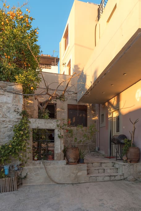 Outside, small yard and the balcony on the left at the first floor and second floor are visible. On the right it's a different house.