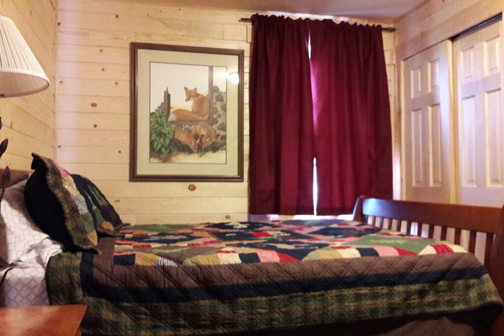 Bedroom with queen bed and twin bunkbed.