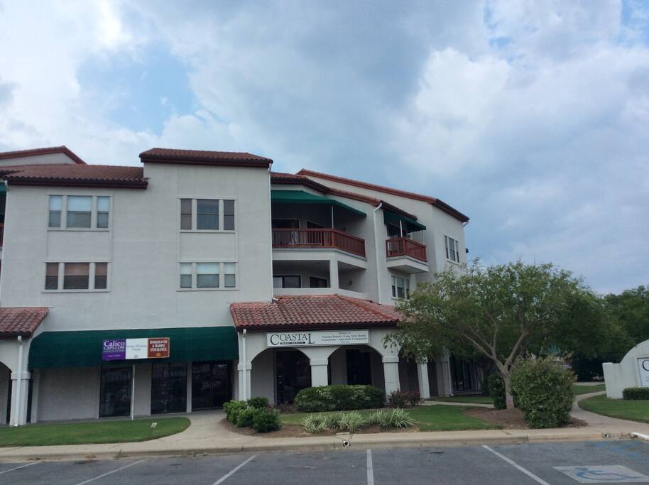 Third floor balcony above shops.