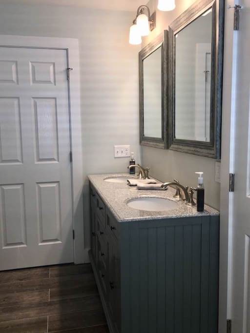 Downstairs bathroom with front load washer and dryer.